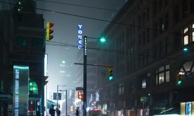 people standing near lamp post and building